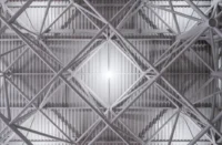 Close-up of the white tubular steel space frame beneath the corrugated roof deck, Zvonařka Bus Station by CH+K
